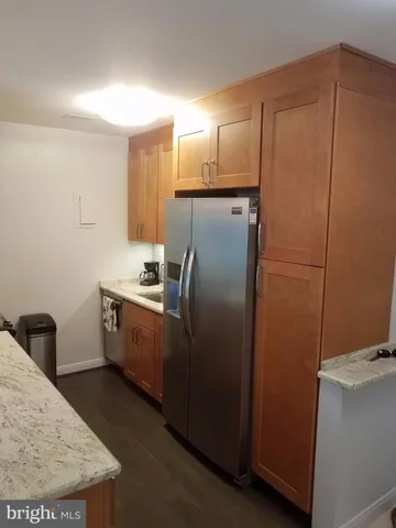 a kitchen with kitchen island granite countertop a sink appliances and cabinets