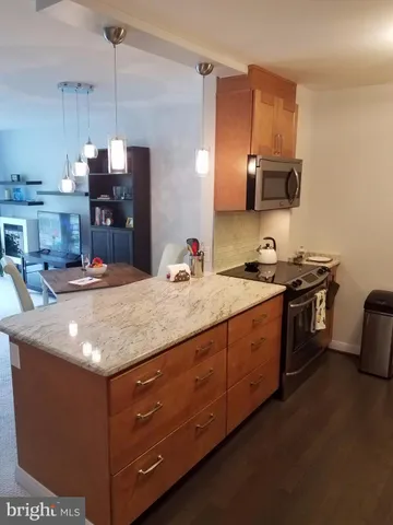 a kitchen with metallic refrigerator freezer and a sink