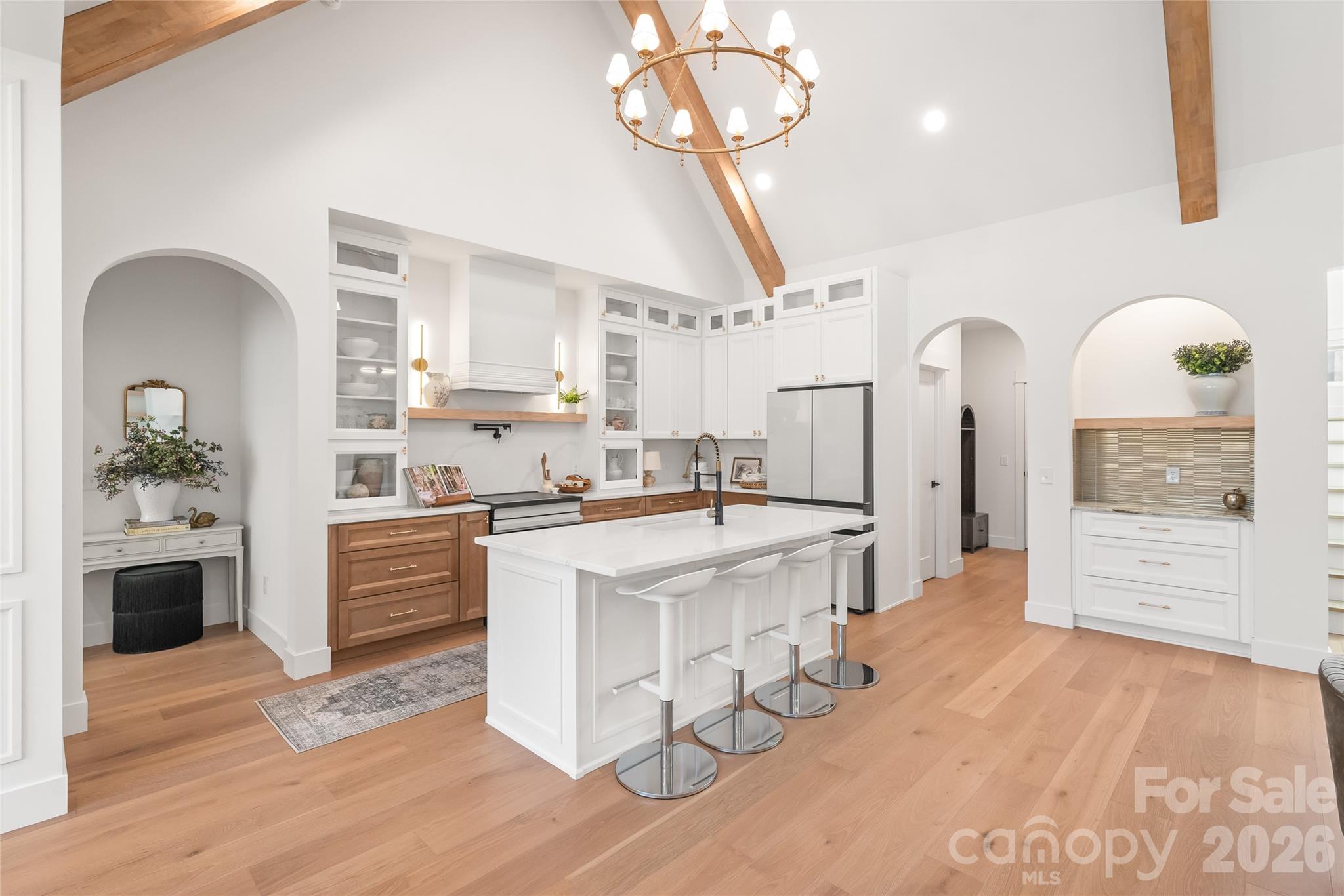 312 Rehobeth Road Waxhaw, NC 28173 - Photo 13 of 41 a large kitchen with kitchen island a stove a sink dishwasher a refrigerator and a dining table with wooden floor