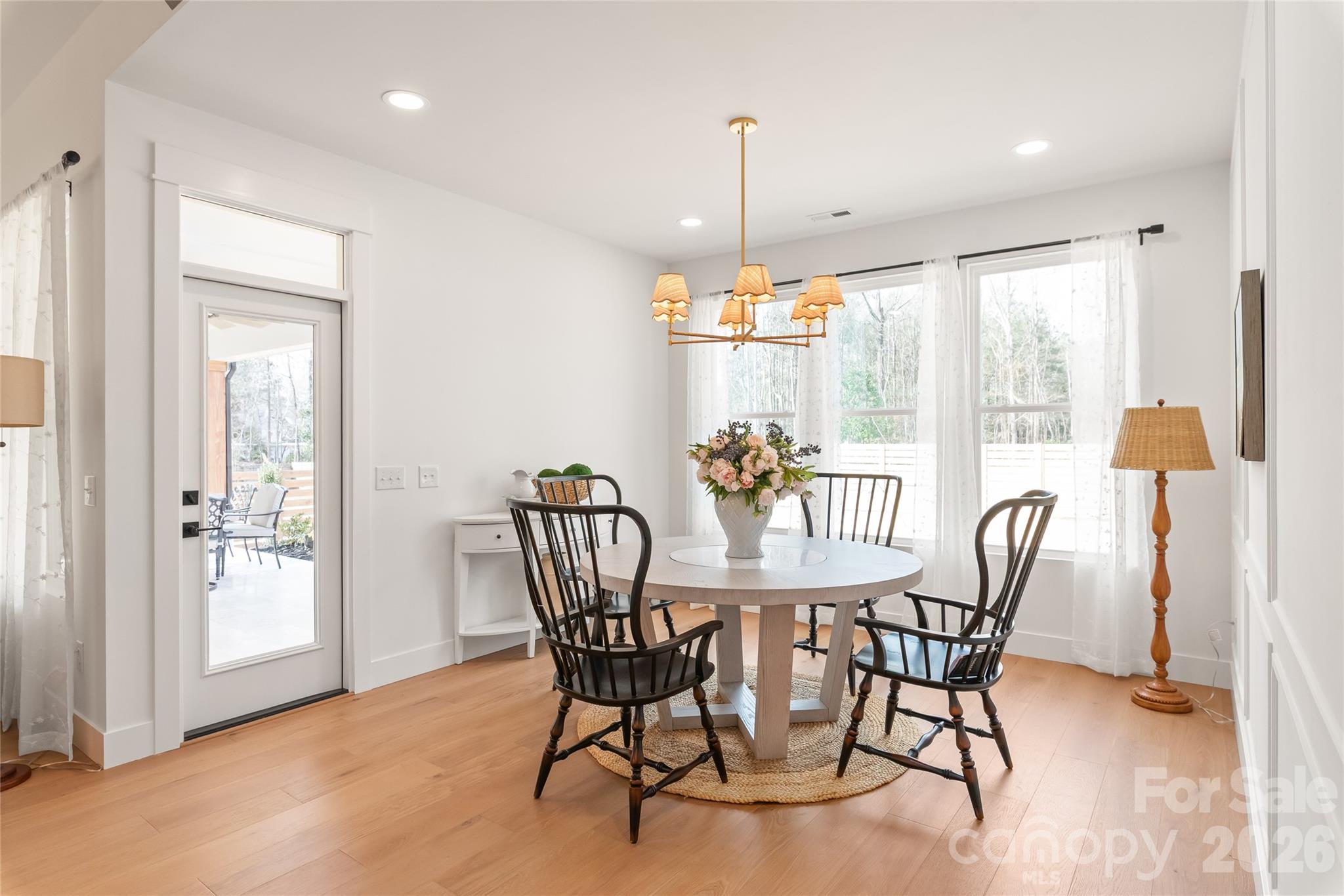 312 Rehobeth Road Waxhaw, NC 28173 - Photo 19 of 41 a view of a dining room and livingroom with furniture wooden floor a chandelier