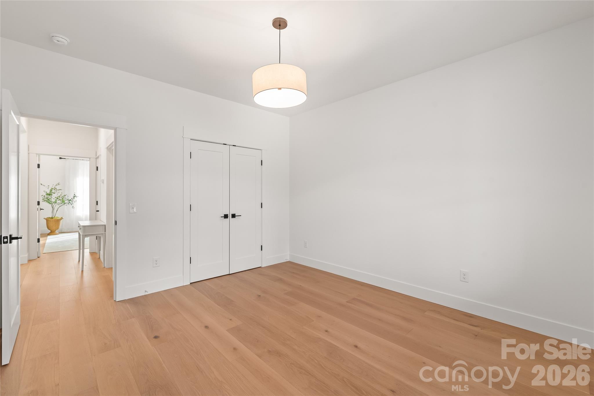 312 Rehobeth Road Waxhaw, NC 28173 - Photo 22 of 41 a view of a room with wooden floor and a chandelier