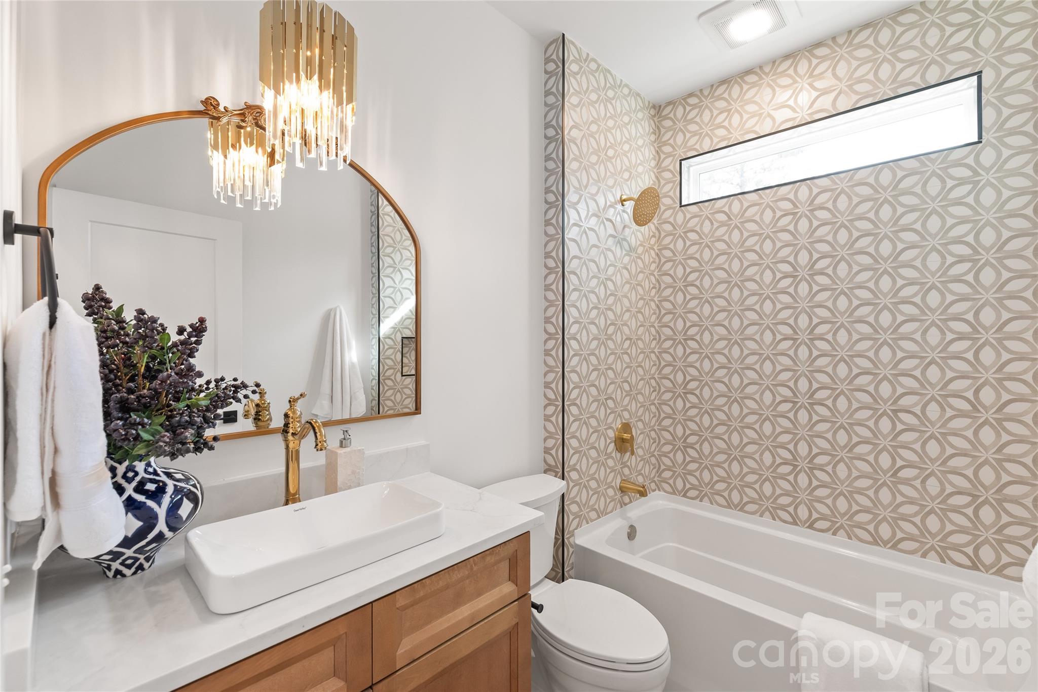 312 Rehobeth Road Waxhaw, NC 28173 - Photo 23 of 41 a bathroom with a granite countertop bathtub sink vanity mirror and toilet