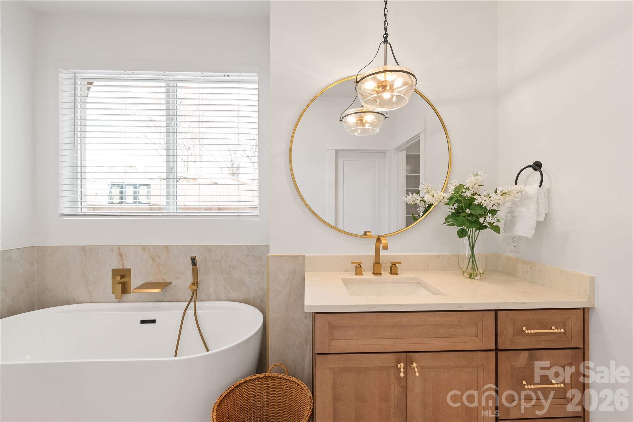 312 Rehobeth Road Waxhaw, NC 28173 - Photo 29 of 41 a bathroom with a sink a mirror a bathtub and a window