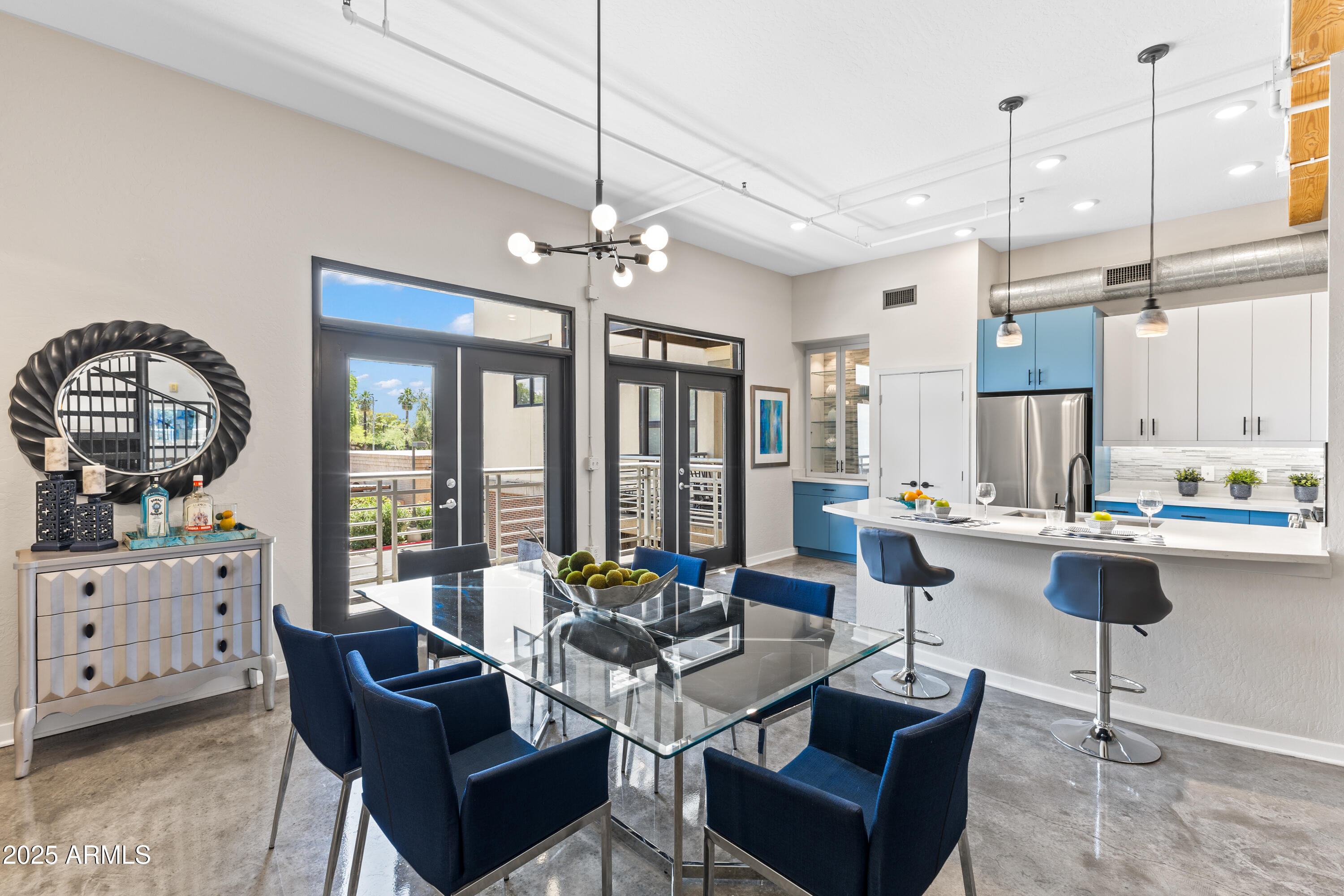 914 East Osborn Road, Unit 208 Phoenix, AZ 85014 - Photo 13 of 53 a living room with furniture a chandelier and a large window