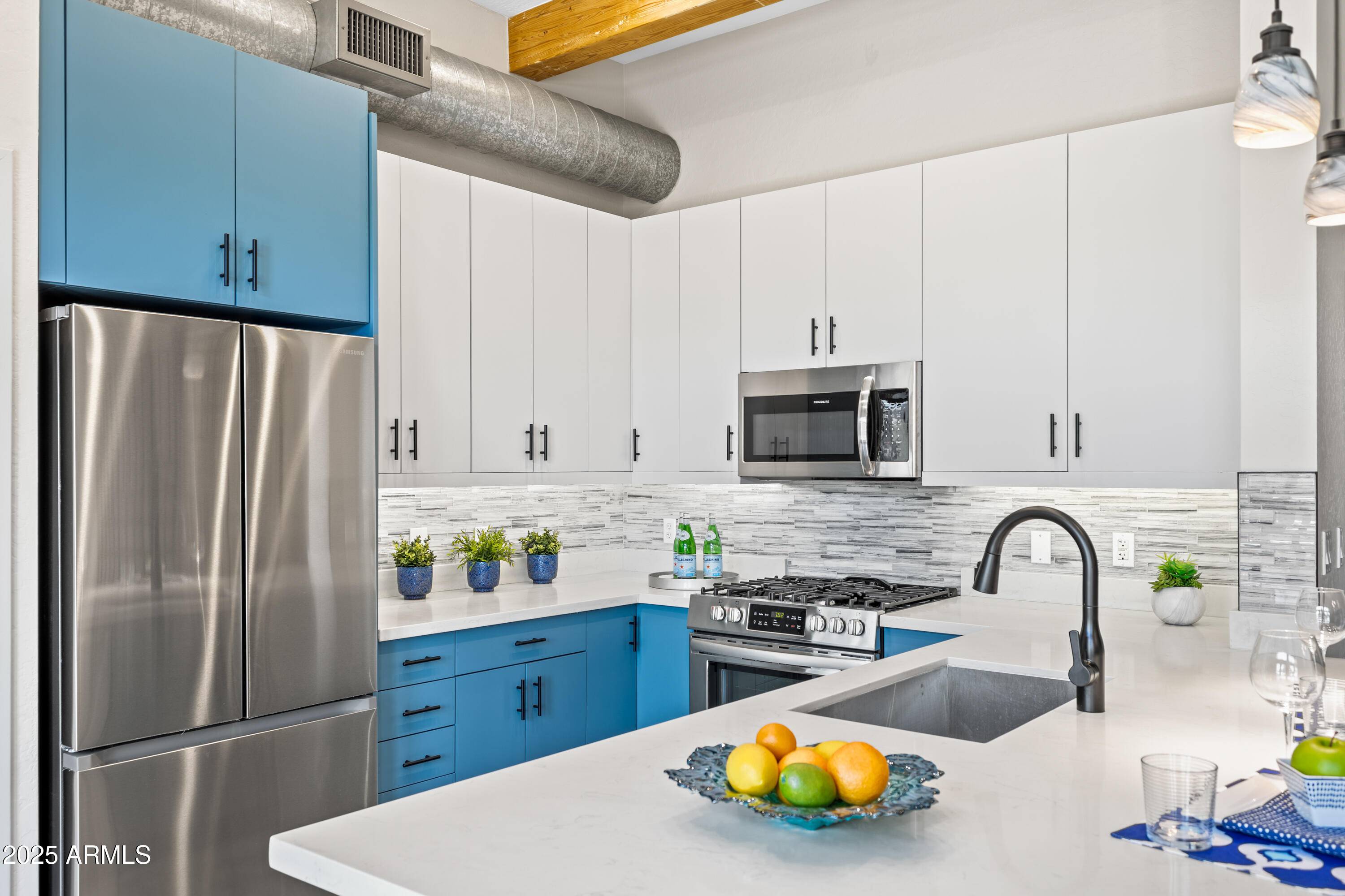 914 East Osborn Road, Unit 208 Phoenix, AZ 85014 - Photo 18 of 53 a kitchen with stainless steel appliances a refrigerator sink and cabinets
