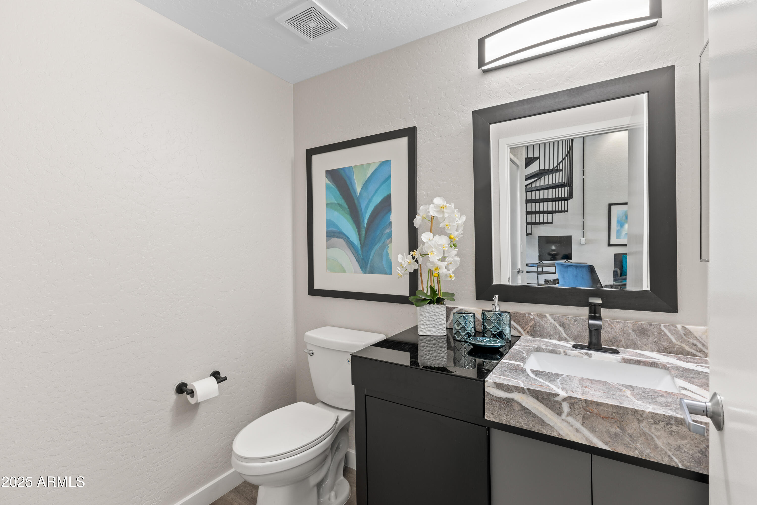 914 East Osborn Road, Unit 208 Phoenix, AZ 85014 - Photo 37 of 53 a bathroom with a granite countertop sink a toilet and a mirror