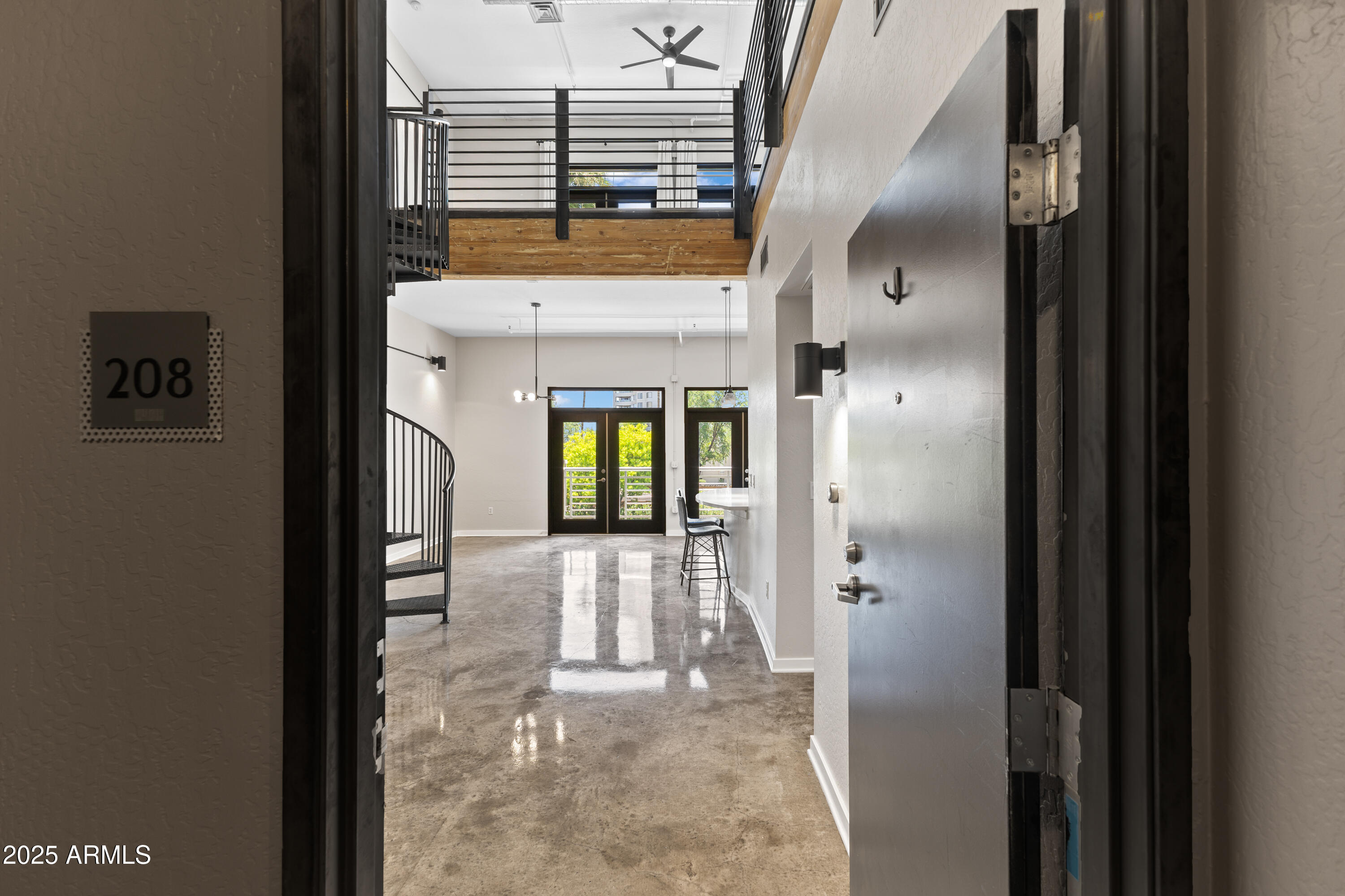 914 East Osborn Road, Unit 208 Phoenix, AZ 85014 - Photo 5 of 53 a view of a hallway with wooden cabinet and living room