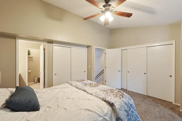 a bedroom with a large bed and a chandelier