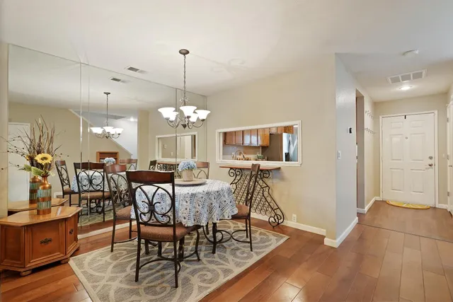 a view of a dining room with furniture and wooden floor