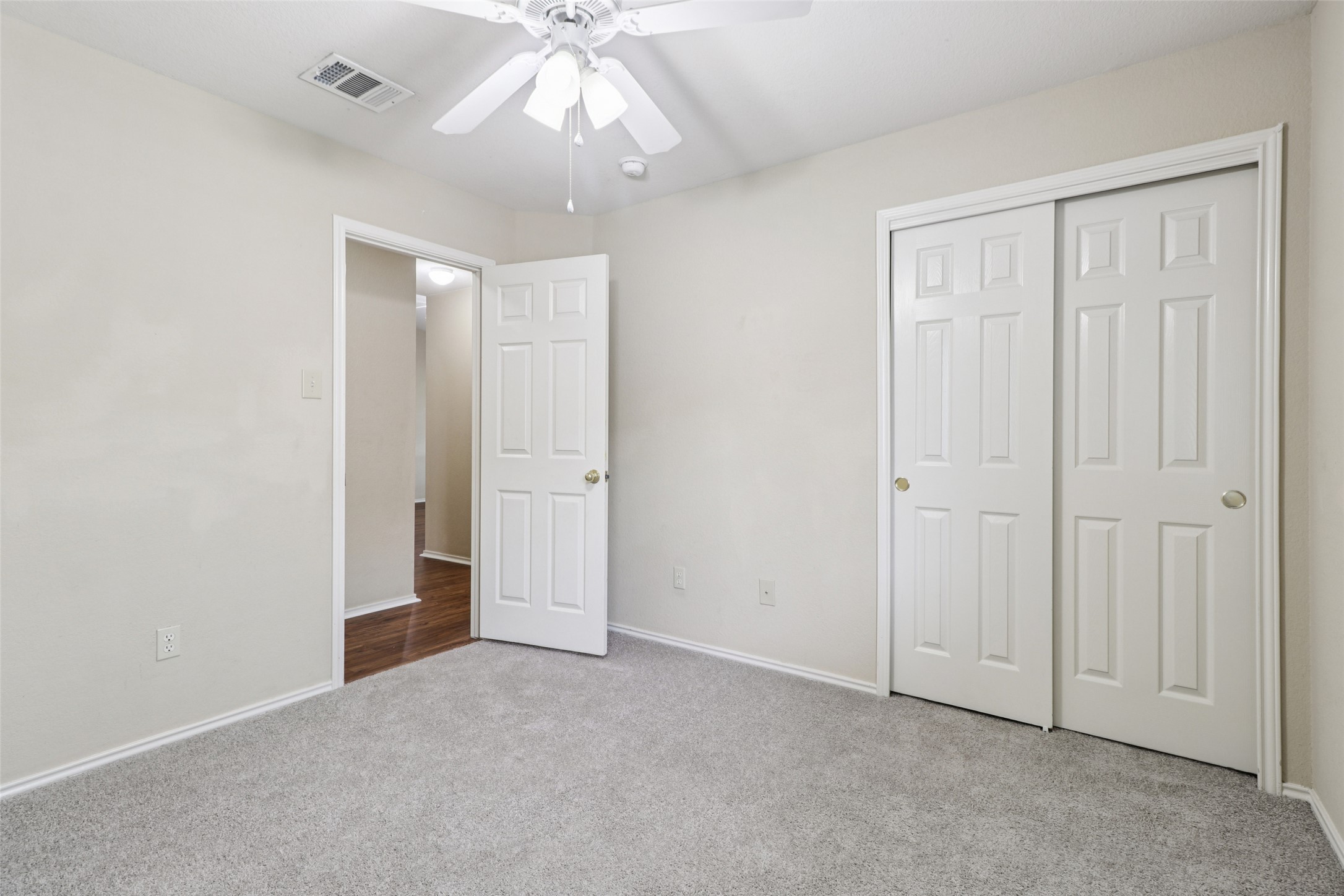 700 Scheel Road Kyle, TX 78640 - Photo 34 of 39 This room features a ceiling fan, light gray carpeting, and white trim