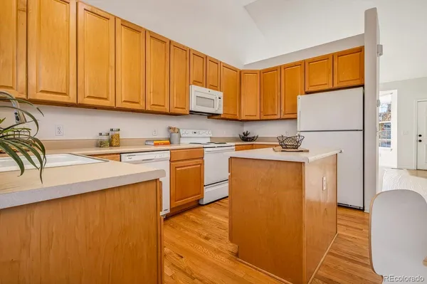 a kitchen with stainless steel appliances granite countertop a refrigerator sink and cabinets