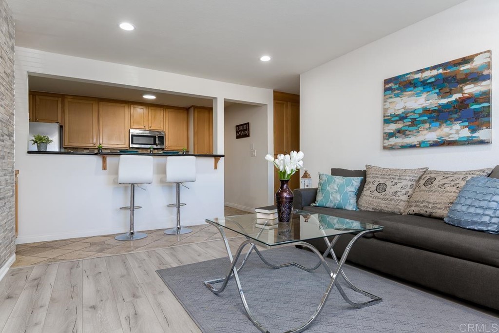 9860 Dale Avenue, Unit D10 Spring Valley, CA 91977 - Photo 1 of 1 a living room with furniture and kitchen view