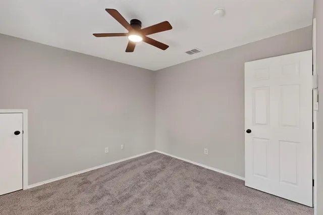 an empty room with ceiling fan and a ceiling fan