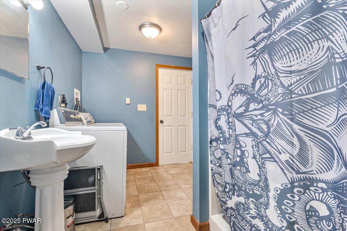 192 Heather Hill Road Dingmans Ferry, PA 18328 - Photo 42 of 74 a bathroom with a sink and mirror with bathtub