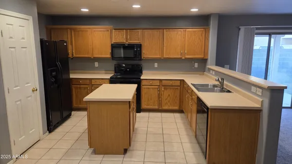 a kitchen with a sink a cabinets and window