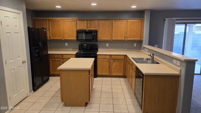a kitchen with a sink a cabinets and window