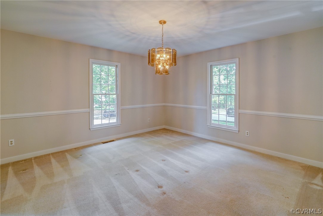 3909 Cheyenne Road Richmond, VA 23235 - Photo 16 of 47 an empty room with windows and chandelier fan