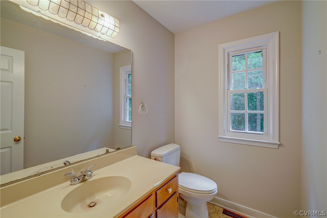 3909 Cheyenne Road Richmond, VA 23235 - Photo 28 of 47 a bathroom with a sink a toilet and a mirror