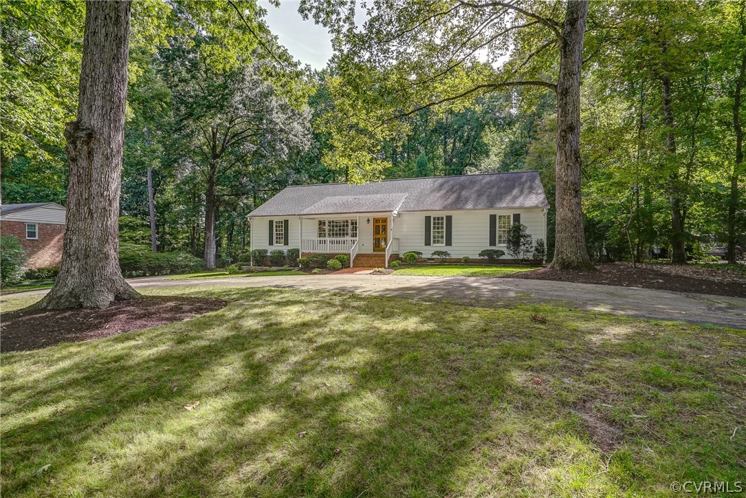 3909 Cheyenne Road Richmond, VA 23235 - Photo 4 of 47 a front view of a house with a yard table and chairs