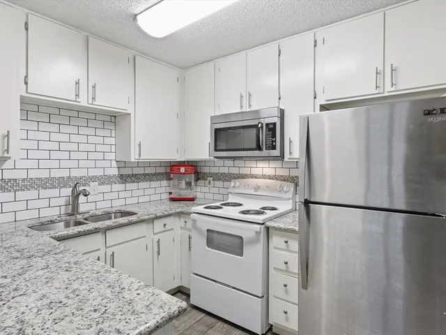 a kitchen with a sink stove and refrigerator