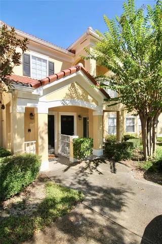 a view of a house with a tree in front of it