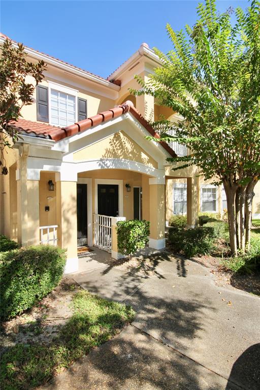 a view of a house with a tree in front of it