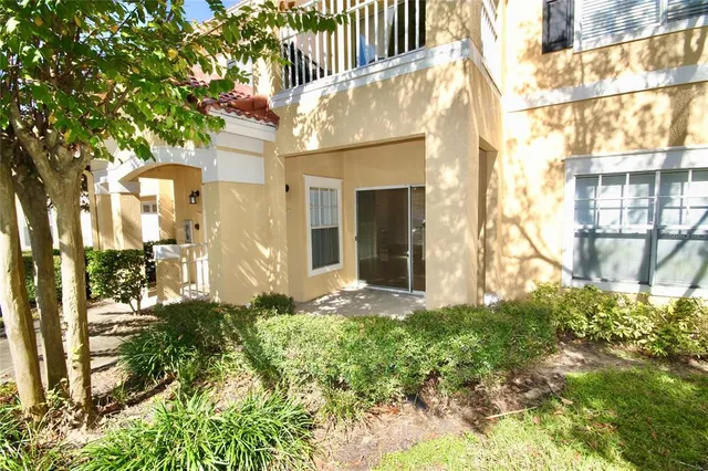 front view of a brick house with a small yard