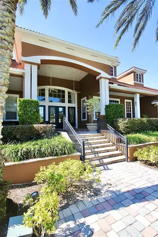 a view of a swimming pool with a patio and a yard