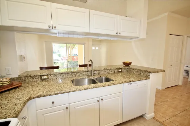 a kitchen with a stove a sink and a refrigerator