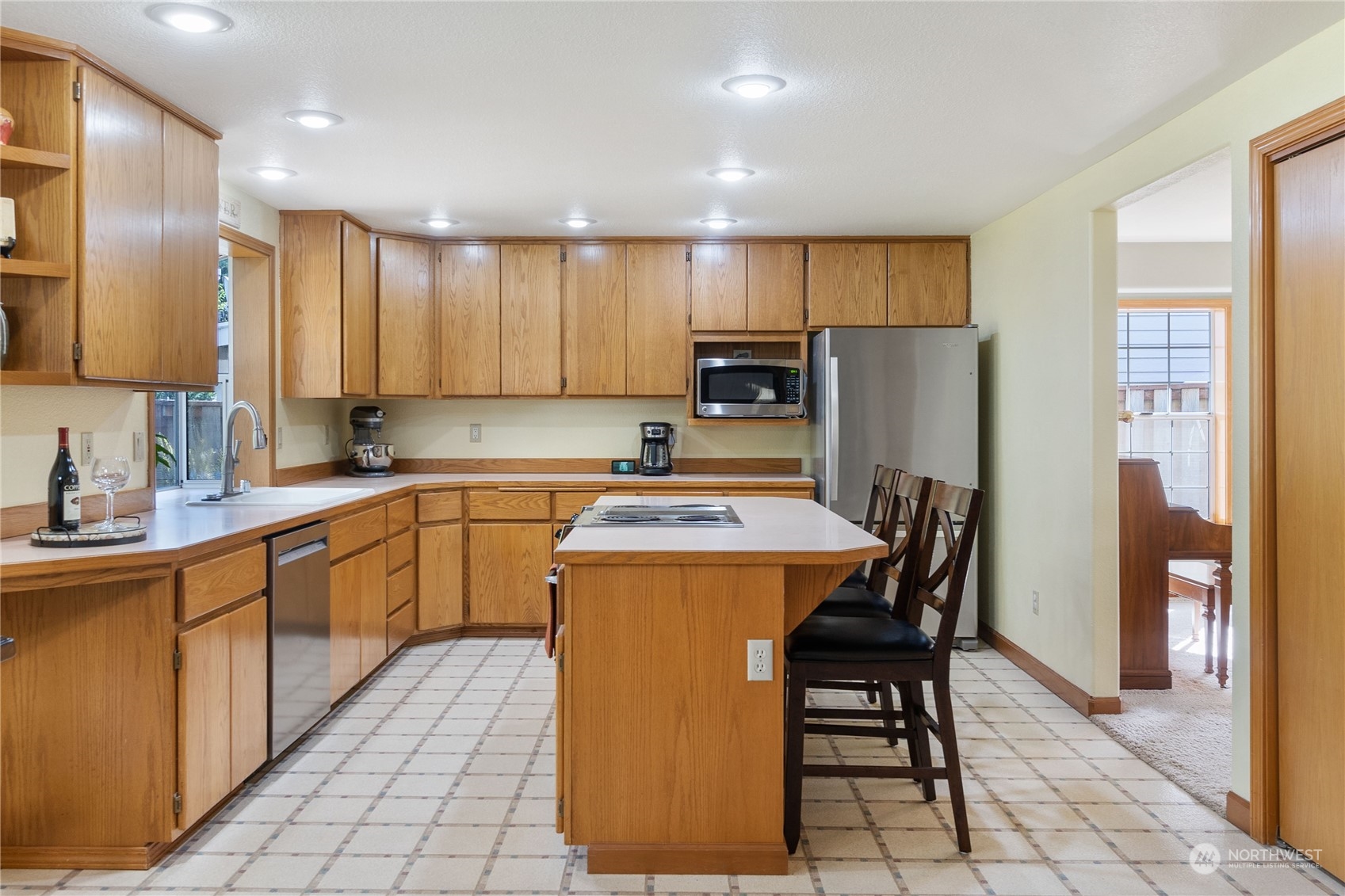 2540 Walnut Loop Northwest Olympia, WA 98502 - Photo 14 of 30 a kitchen with a table chairs refrigerator and cabinets