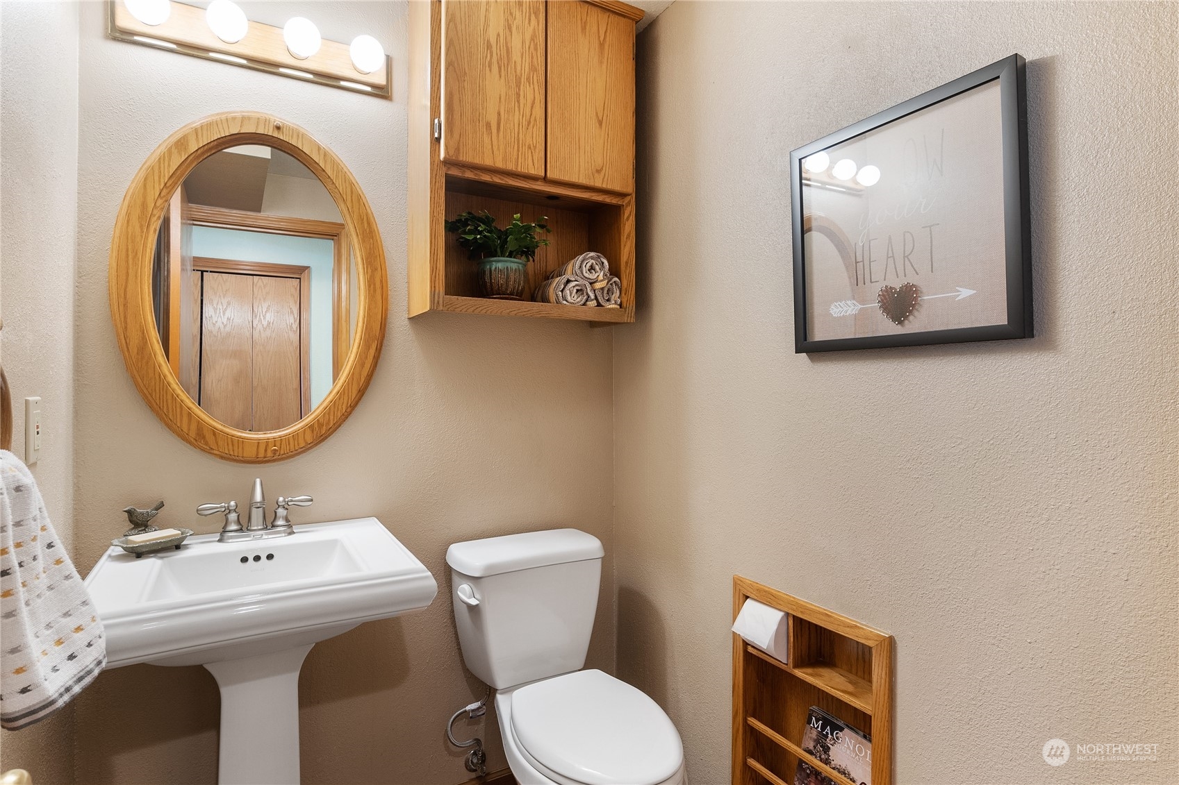 2540 Walnut Loop Northwest Olympia, WA 98502 - Photo 18 of 30 a bathroom with a toilet a sink and a mirror