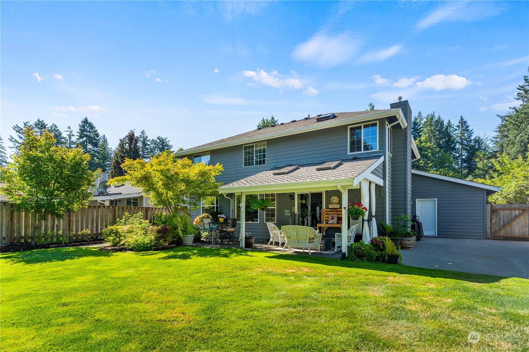 2540 Walnut Loop Northwest Olympia, WA 98502 - Photo 2 of 30 a view of a house with a big yard potted plants and large tree