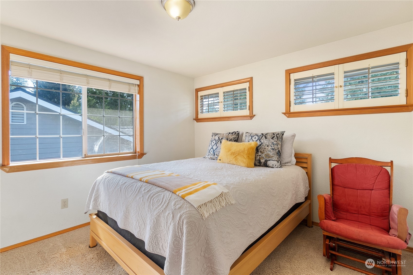 2540 Walnut Loop Northwest Olympia, WA 98502 - Photo 26 of 30 a bedroom with a bed and a couch with exposed radiator