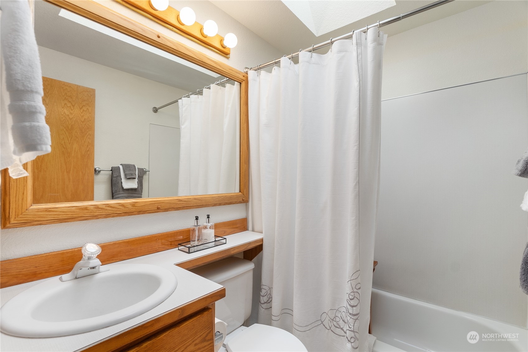 2540 Walnut Loop Northwest Olympia, WA 98502 - Photo 27 of 30 a bathroom with a sink and a mirror