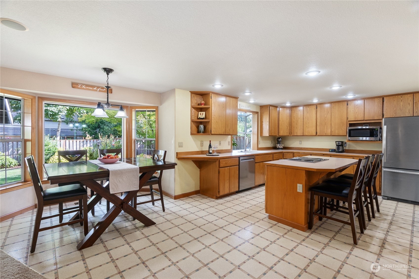 2540 Walnut Loop Northwest Olympia, WA 98502 - Photo 10 of 30 a kitchen with a dining table chairs and white cabinets