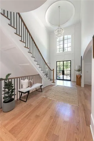 a living room with furniture a fireplace and a large mirror