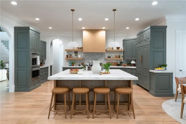 a spacious bedroom with a bed and a chandelier