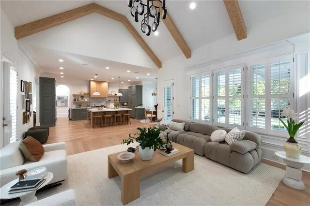a living room with fireplace furniture and a large window