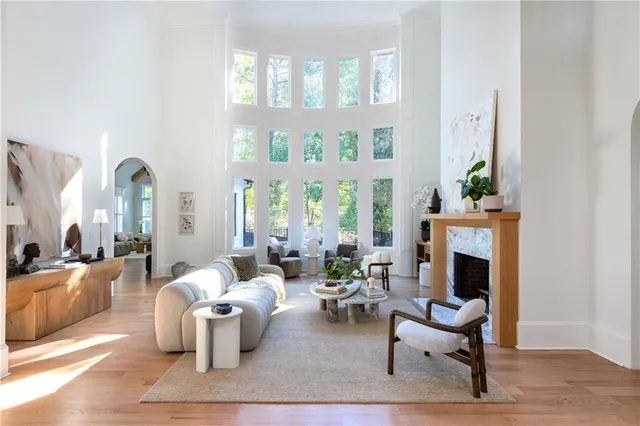 a spacious bedroom with a bed a couch and a chandelier