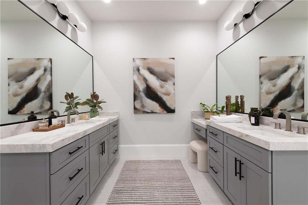 2079 Old Settlement Road Northwest Atlanta, GA 30327 - Photo 34 of 78 a bathroom with a double vanity sink and mirror