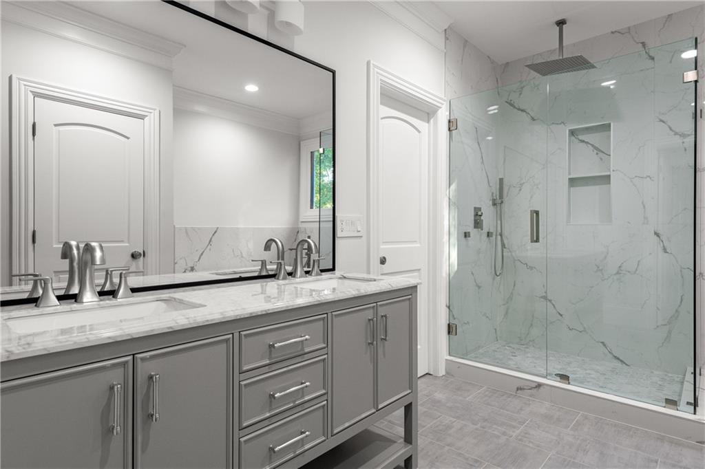 2079 Old Settlement Road Northwest Atlanta, GA 30327 - Photo 42 of 78 a bathroom with a granite countertop sink mirror and double