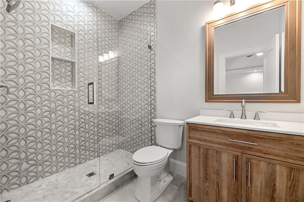 2079 Old Settlement Road Northwest Atlanta, GA 30327 - Photo 46 of 78 a bathroom with a sink a toilet and shower