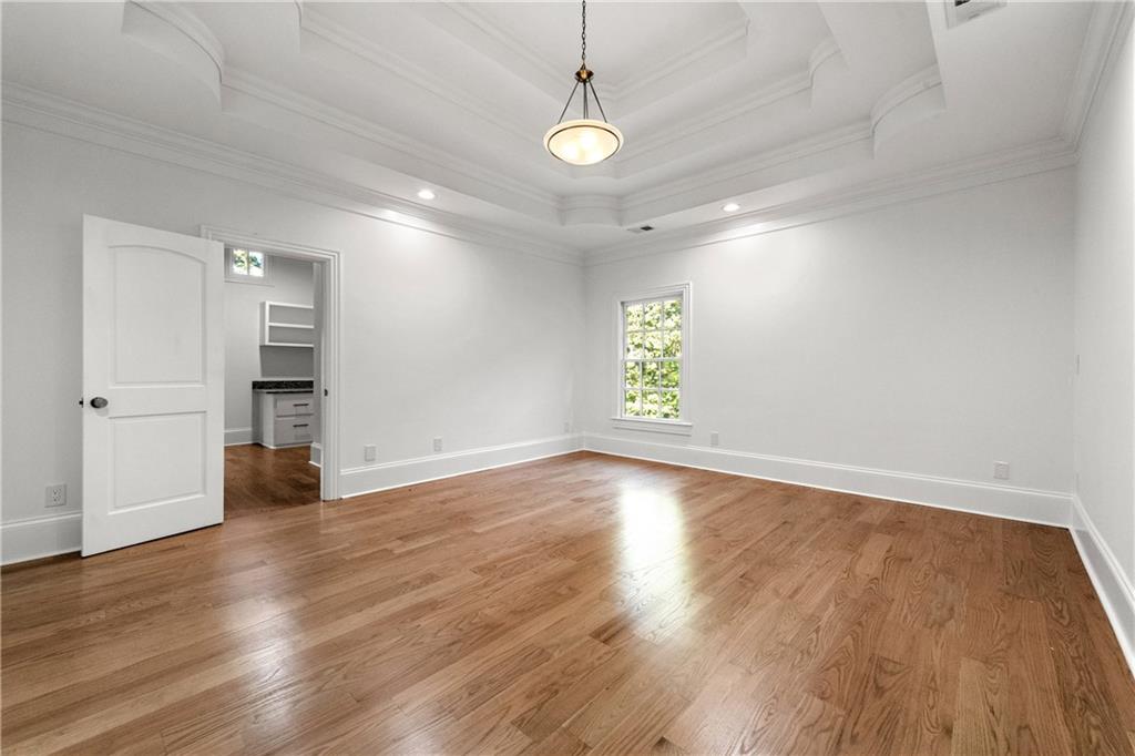 2079 Old Settlement Road Northwest Atlanta, GA 30327 - Photo 47 of 78 an empty room with wooden floor and windows