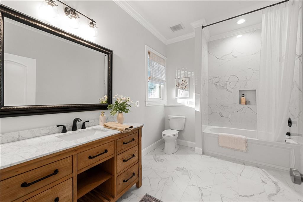 2079 Old Settlement Road Northwest Atlanta, GA 30327 - Photo 62 of 78 a bathroom with a double vanity sink toilet mirror and bathtub