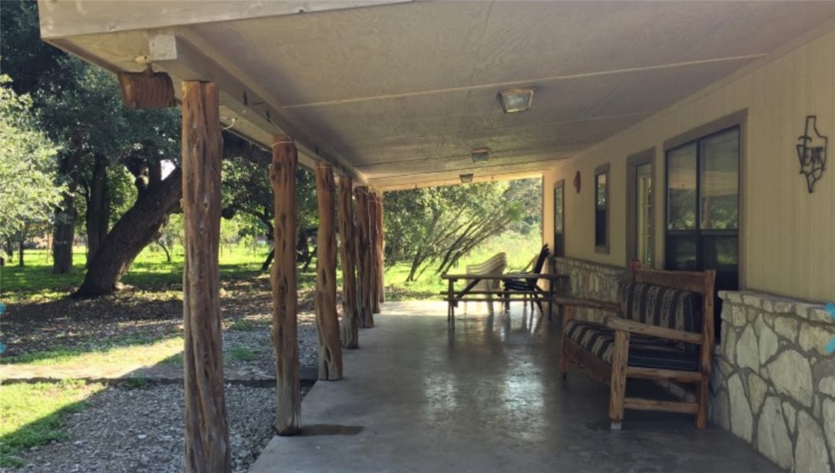 197 Tomahawk Way Concan, TX 78838 - Photo 2 of 18 a view of a porch with chairs and backyard
