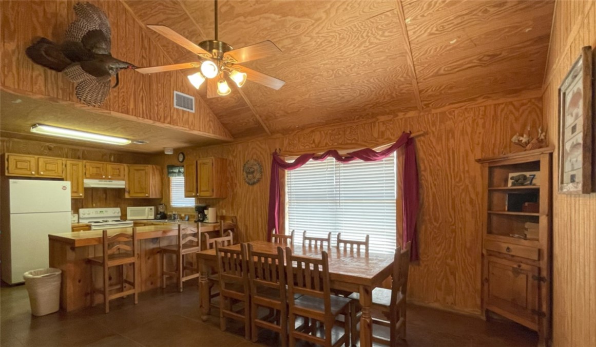 197 Tomahawk Way Concan, TX 78838 - Photo 7 of 18 a view of a dining room with furniture window and outside view