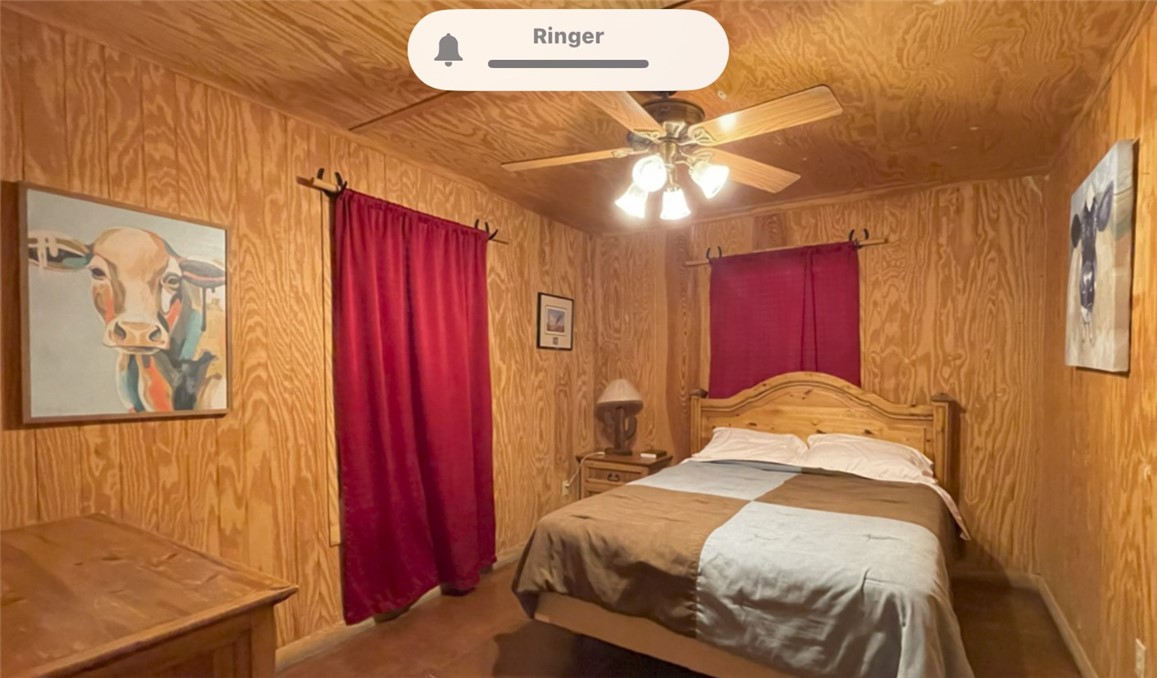 197 Tomahawk Way Concan, TX 78838 - Photo 8 of 18 a bedroom with a bed and a chandelier