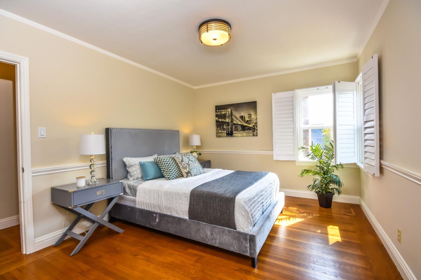 1100 Rosedale Avenue Burlingame, CA 94010 - Photo 5 of 15 a bedroom with a bed lamp and a potted plant