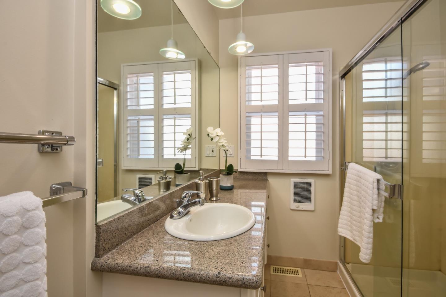 1100 Rosedale Avenue Burlingame, CA 94010 - Photo 7 of 15 a bathroom with a granite countertop sink and a mirror