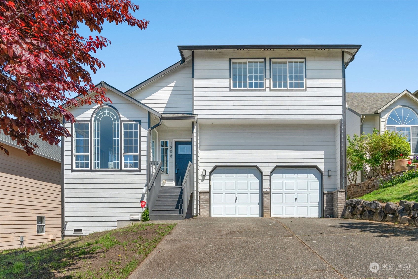 1208 South 35th Street Renton, WA 98055 - Photo 1 of 26 a front view of a house with garage and parking space